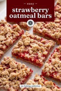 Close up view of sliced strawberry oatmeal bars on a piece of parchment paper. Text overlay includes recipe name.