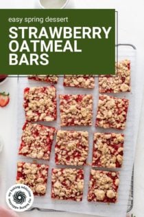Overhead view of sliced strawberry oatmeal bars on a wire rack. Text overlay includes recipe name.