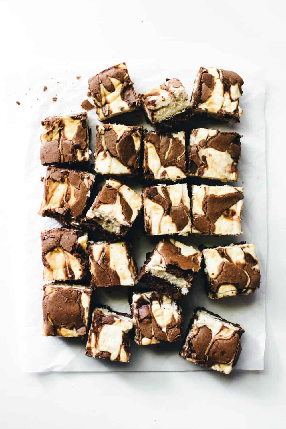 Overhead view of sliced tiramisu brownies on parchment paper