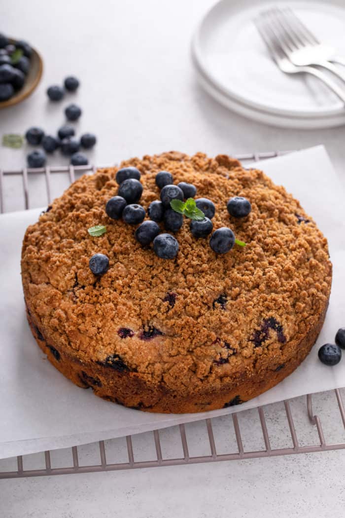 Baked blueberry buckle on a wire cooling rack.