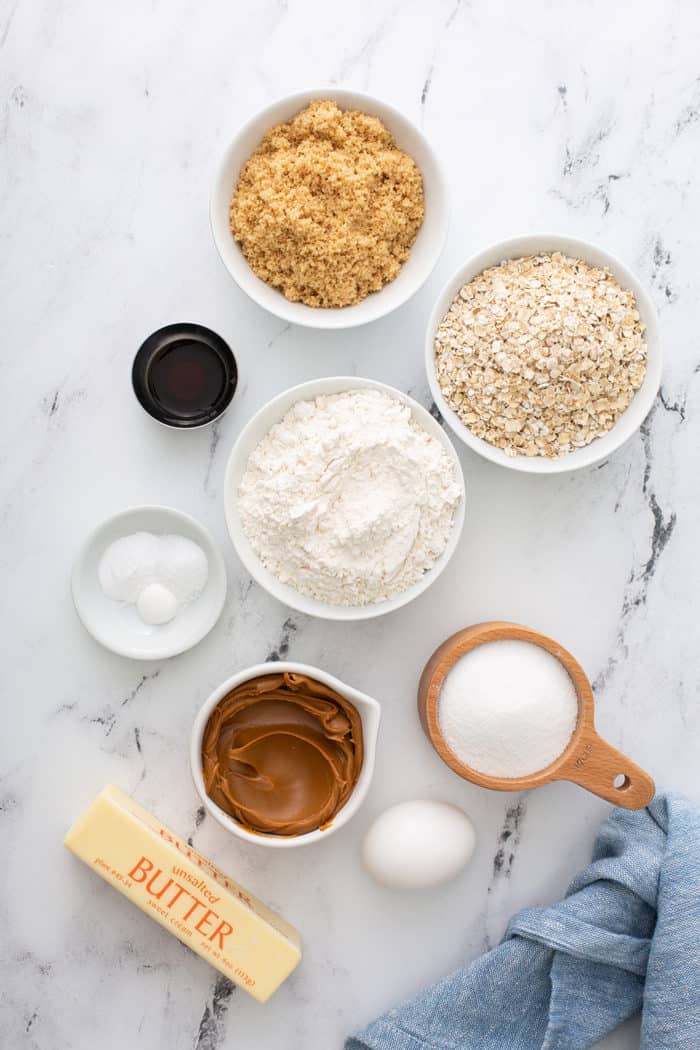 Ingredients for biscoff sandwich cookies arranged on a marble countertop