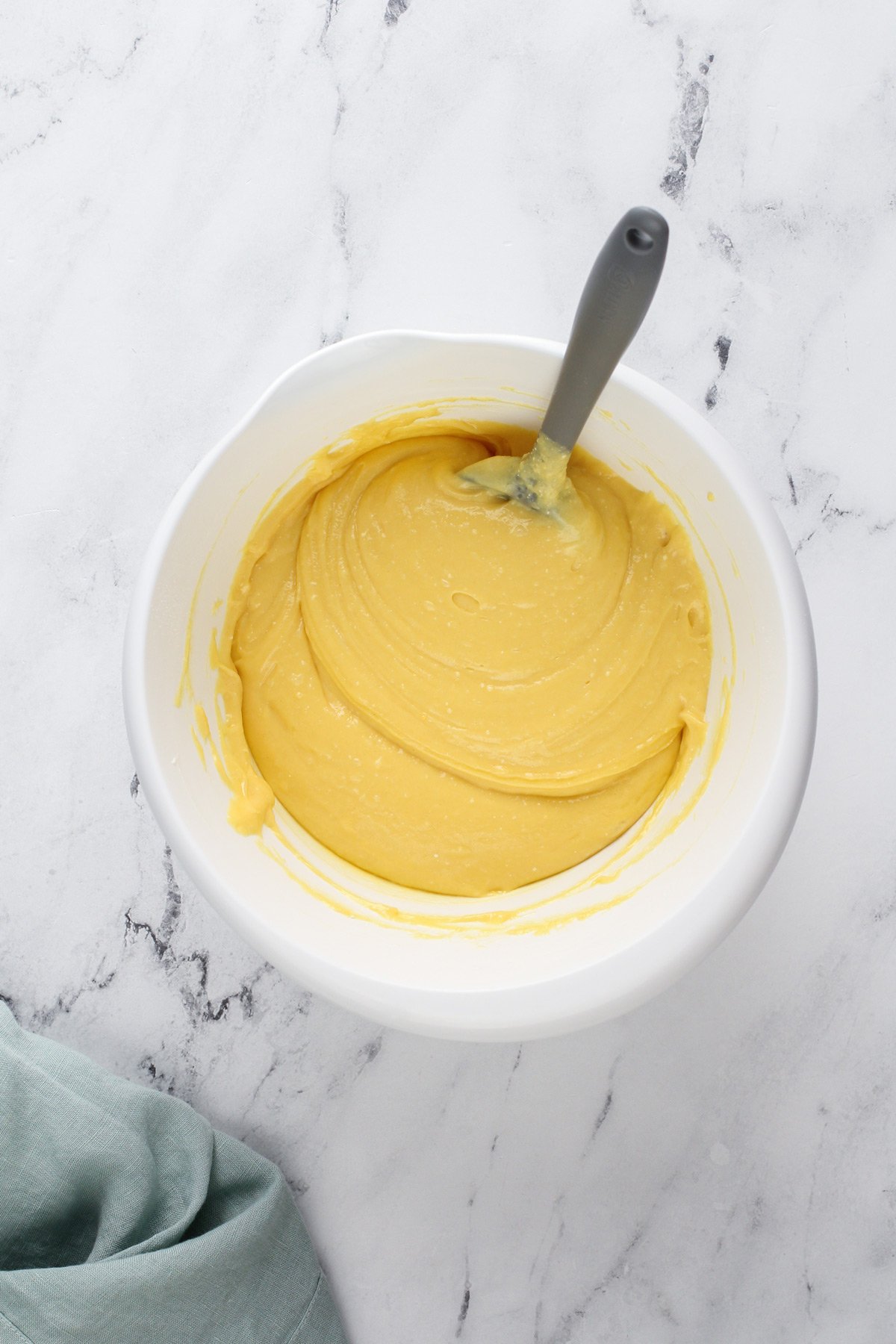 Cake batter base for chocolate chip bundt cake in a white mixing bowl.