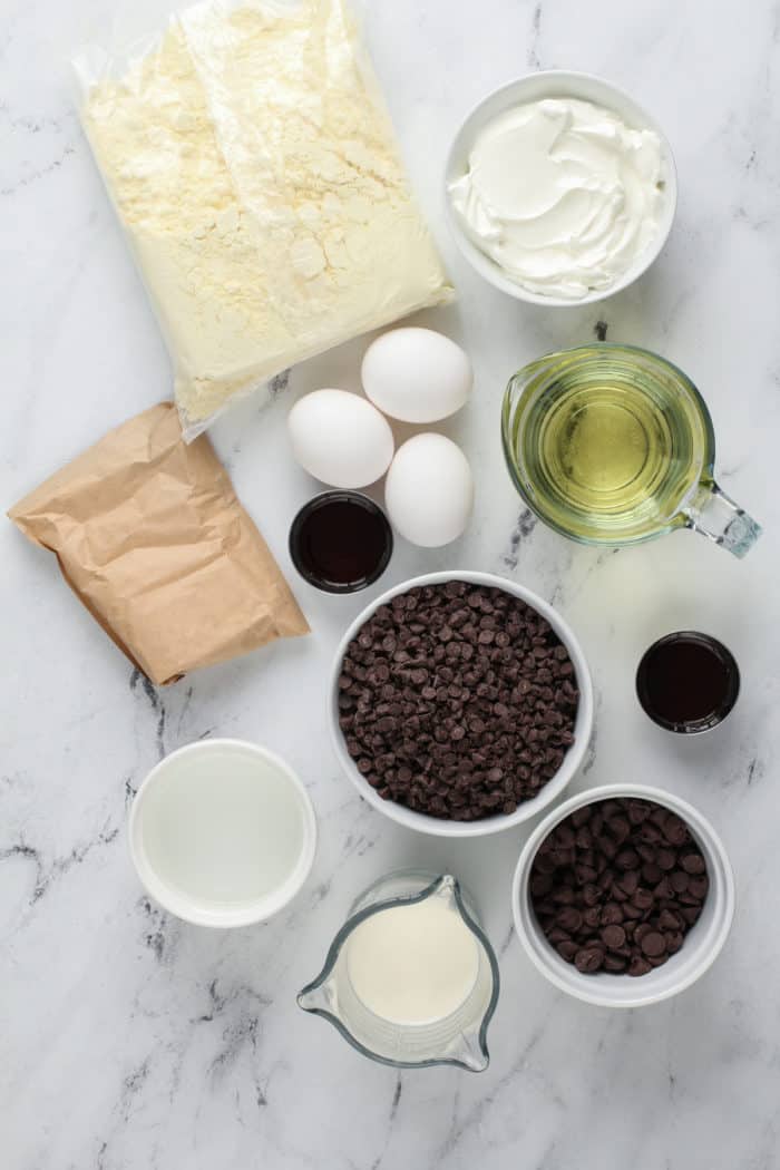 Chocolate chip bundt cake ingredients arranged on a marble countertop.