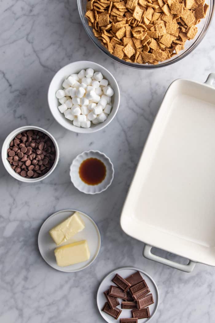 Ingredients for golden graham s'mores on a marble countertop.