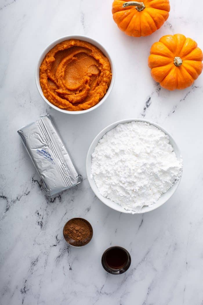 Ingredients for pumpkin dip on a marble countertop