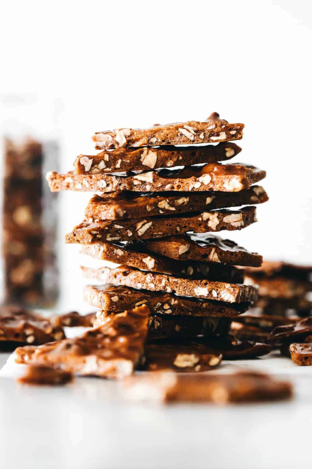 Pieces of pecan brittle stacked on top of each other