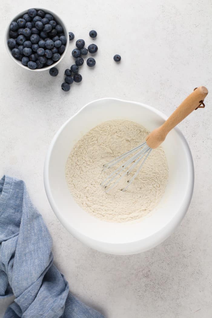 Dry ingredients for blueberry scones whisked together in a white mixing bowl.