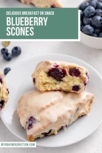 Two blueberry scones on a white plate. One of the scones is broken in half to show the texture of the crumb. Text overlay includes recipe name.