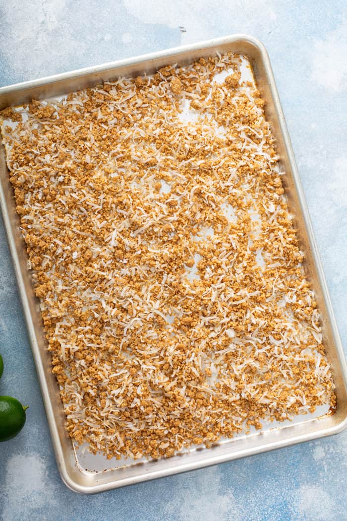 coconut graham cracker crumble for key lime cheesecakes on a baking sheet