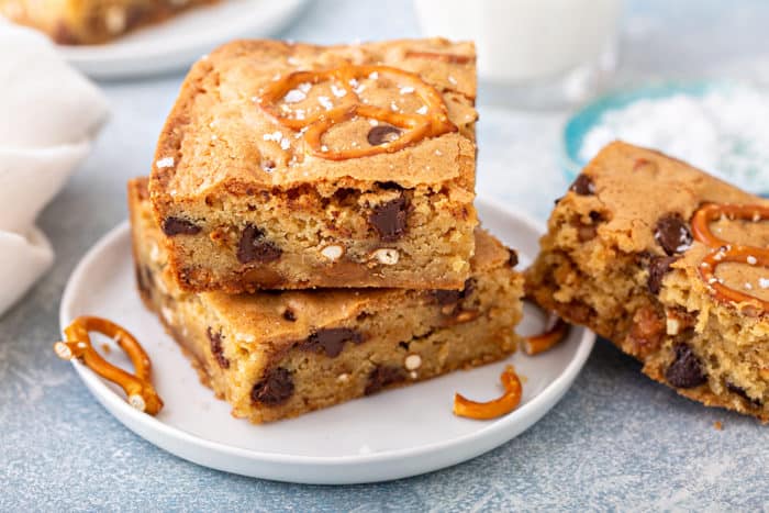 Stacked salted caramel blondies on a white plate