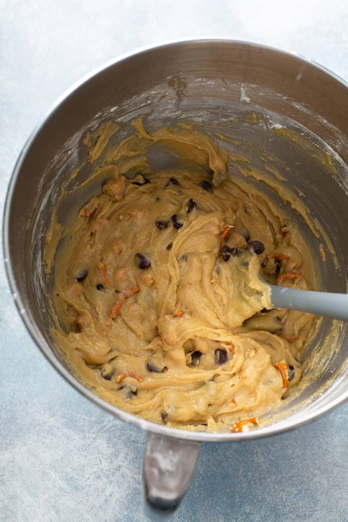 Batter for salted caramel blondies with pretzels in a metal mixing bowl