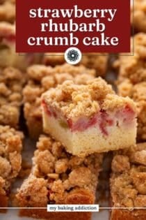 Slice of strawberry rhubarb cake stacked on other slices of the cake. Text overlay includes recipe name.