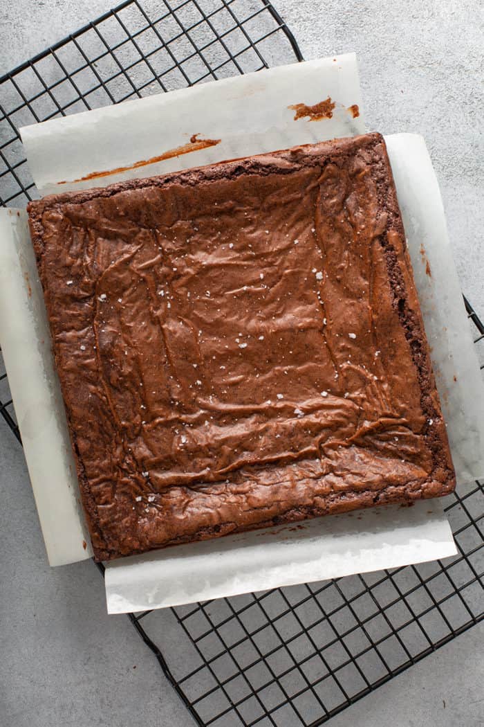 Baked salted caramel brownies on a wire cooling rack