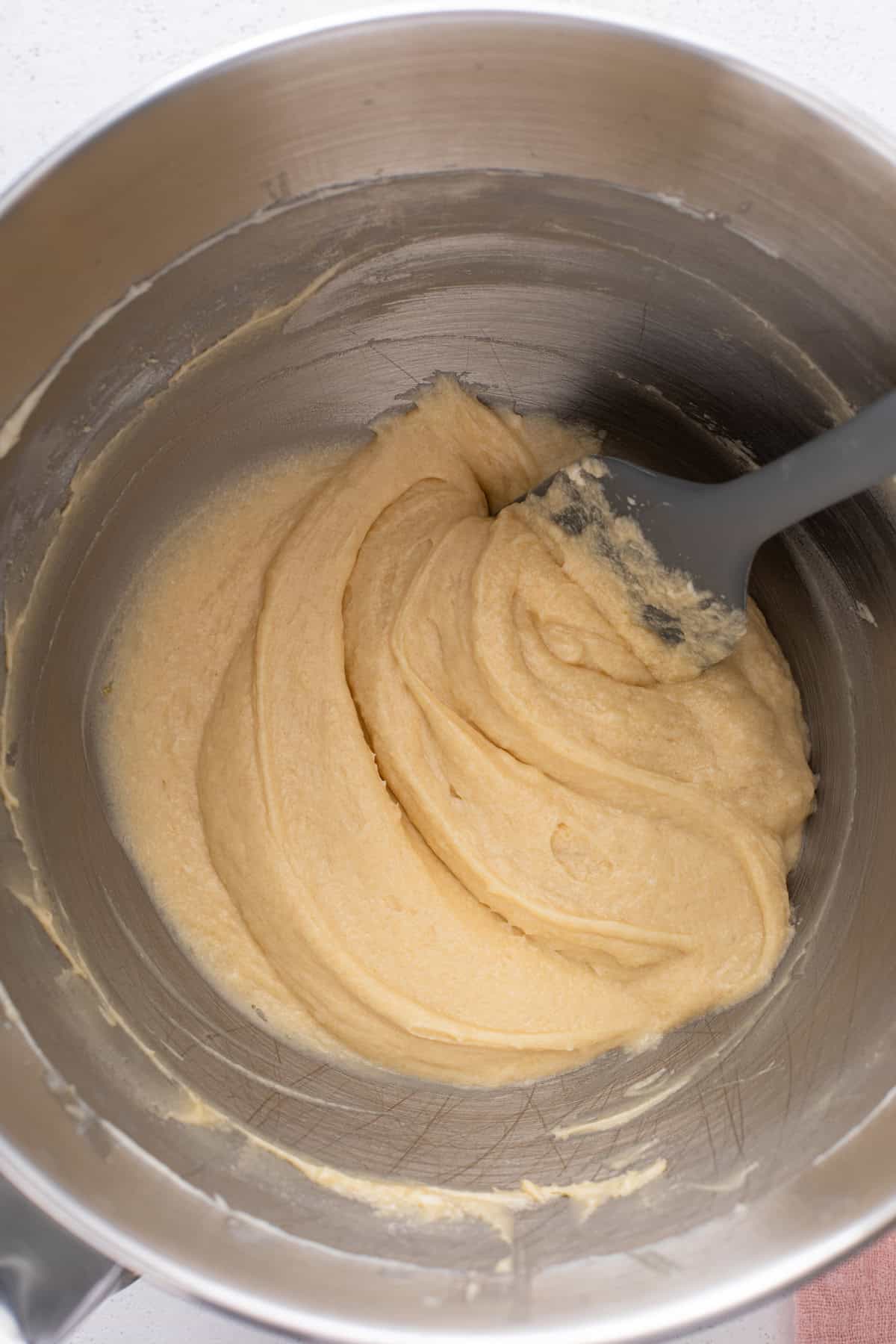 Batter for strawberry rhubarb cake mixed in a bowl.
