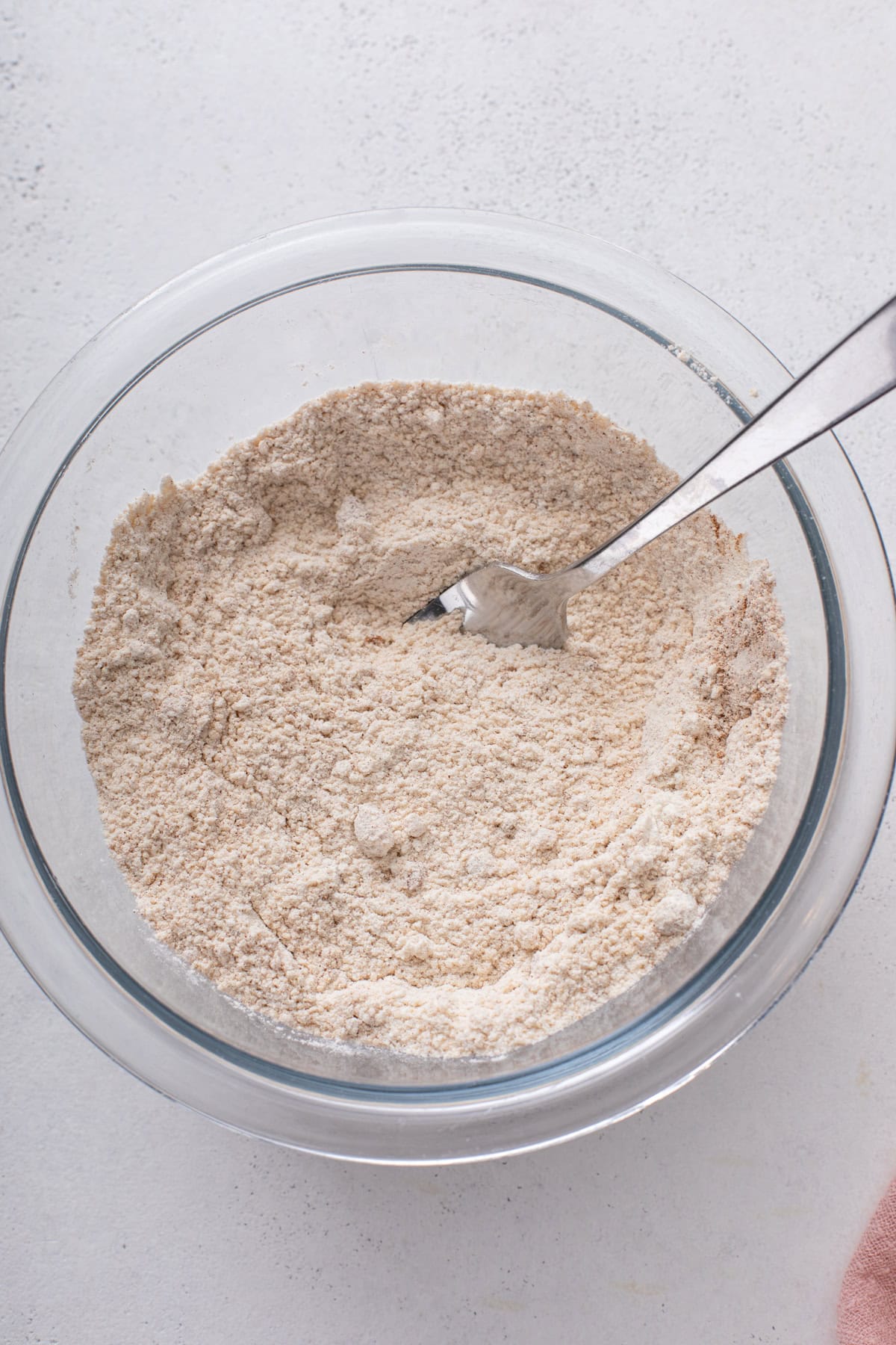 Dry ingredients for streusel topping mixed in a glass bowl.