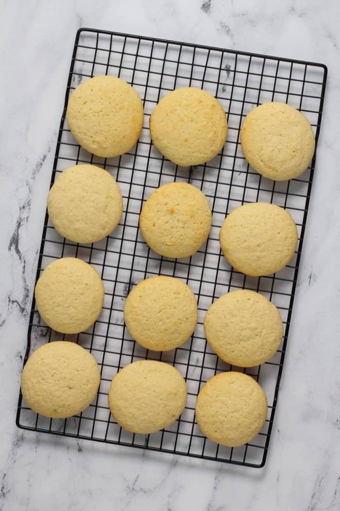 Lemon ricotta cookies cooling on a wire rack.