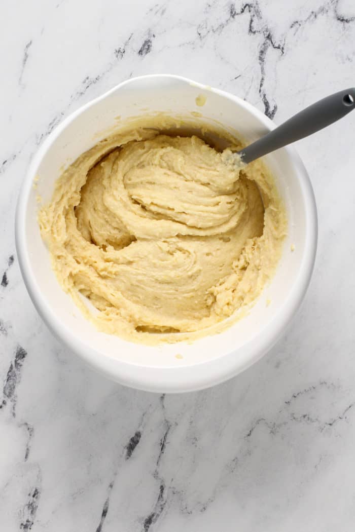 Lemon ricotta cookie dough in a white mixing bowl.