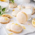 Lemon ricotta cookies arranged next to a glass of milk.