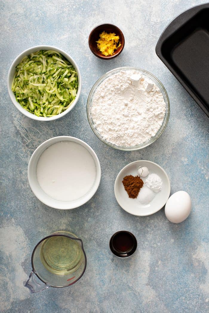 Overhead view of an assortment of bowls holding the ingredients for lemon zucchini bread