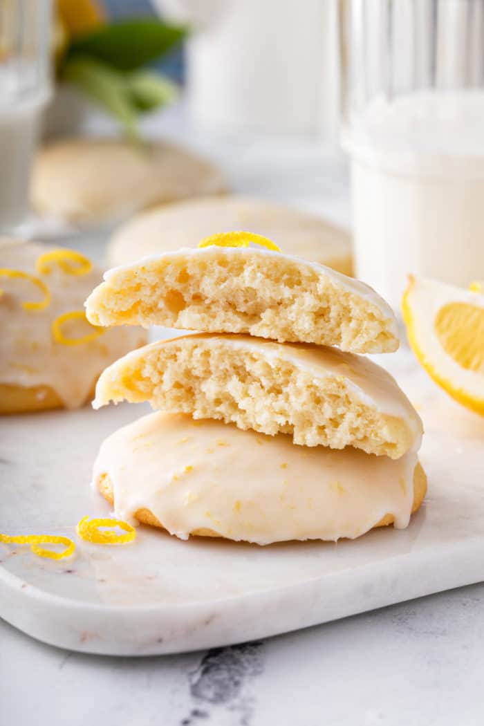 Stack of 3 lemon ricotta cookies. The top two cookies are broken in half.