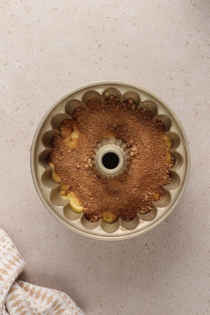 Brown sugar mixture sprinkled over cake batter in a bundt pan.