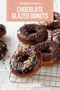 Sprinkle-topped chocolate glazed donuts scattered on a wire cooling rack. Text overlay includes recipe name.