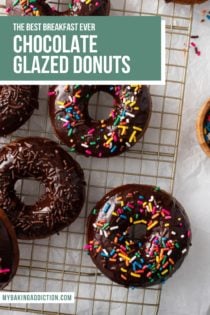 Overhead view of sprinkle-topped chocolate-glazed donuts scattered on a wire rack. Text overlay includes recipe name.