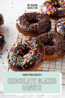 Sprinkle-topped chocolate glazed donuts scattered on a wire cooling rack. Text overly includes recipe name.