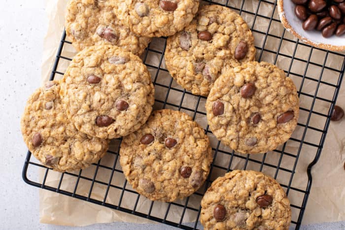 Oatmeal raisin cookies cooling on a wire rack.