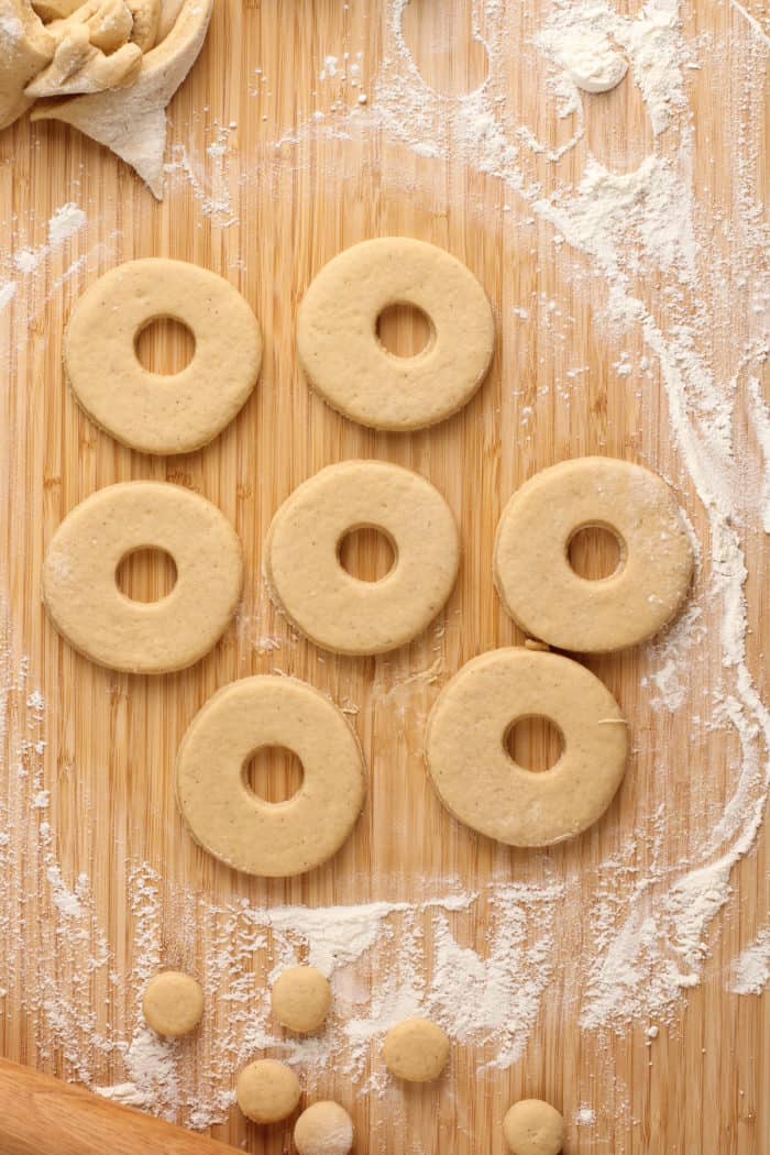 Cut out donuts on a wooden surface.