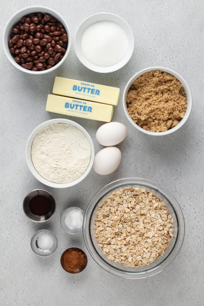 Oatmeal raisin cookie ingredients arranged on a gray countertop.