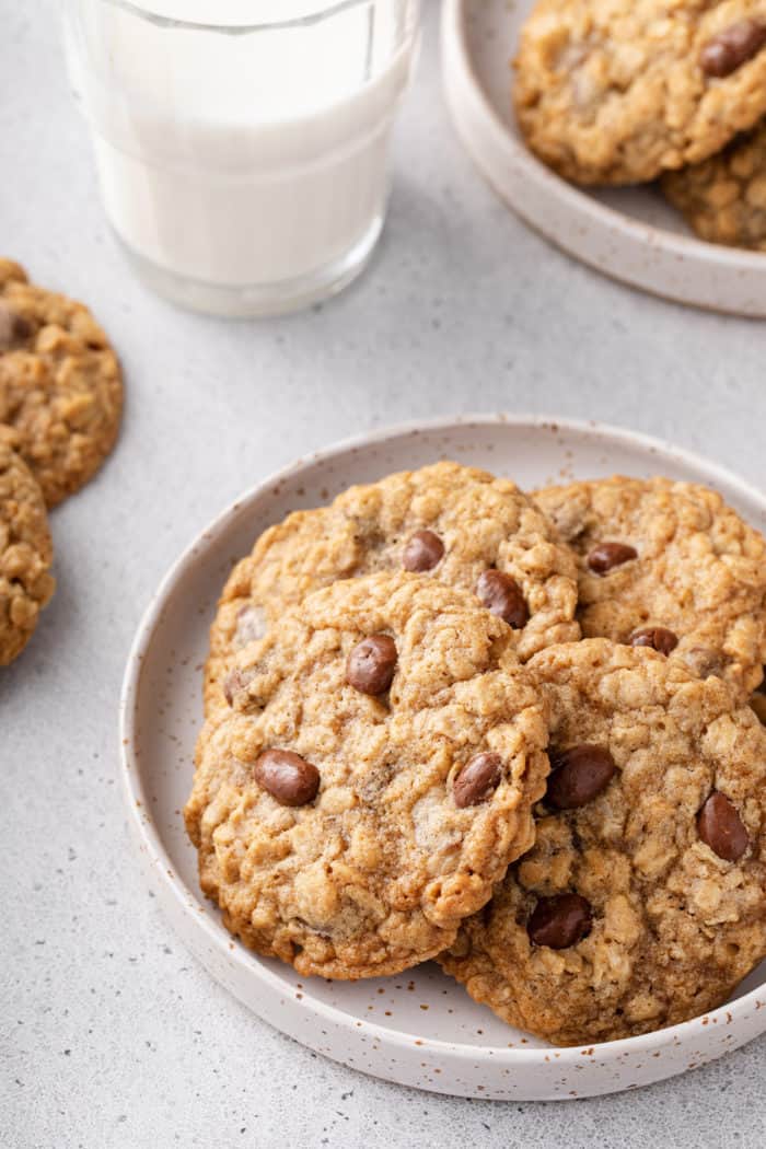 White plate filled with oatmeal raisin cookies made with raisinets.