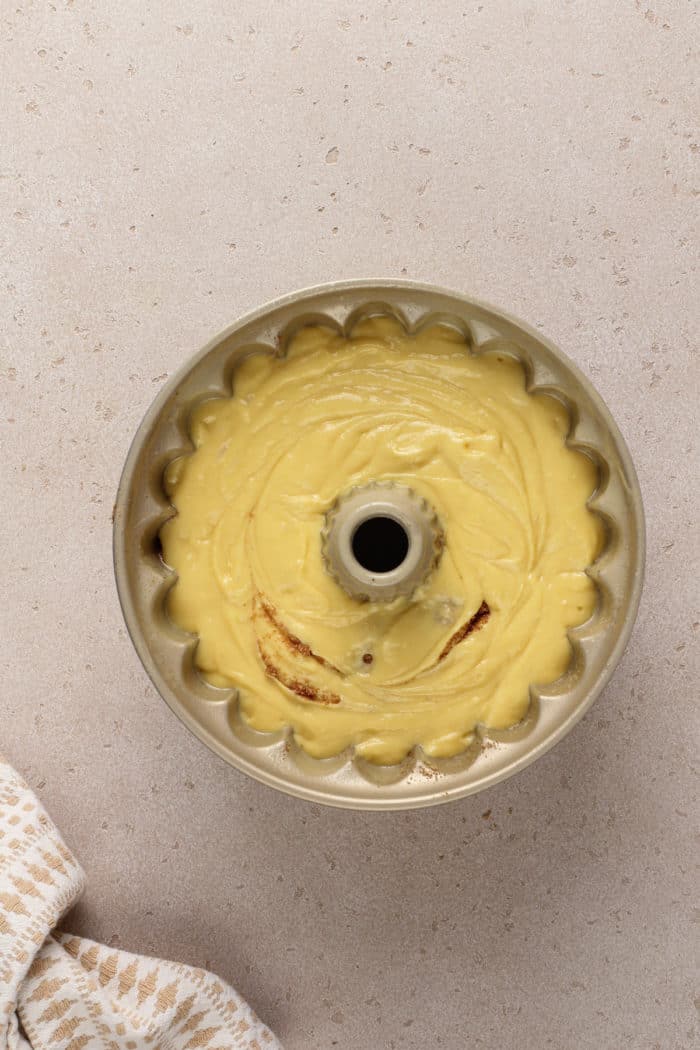 Unbaked honey bun cake in a bundt pan, ready to go in the oven.