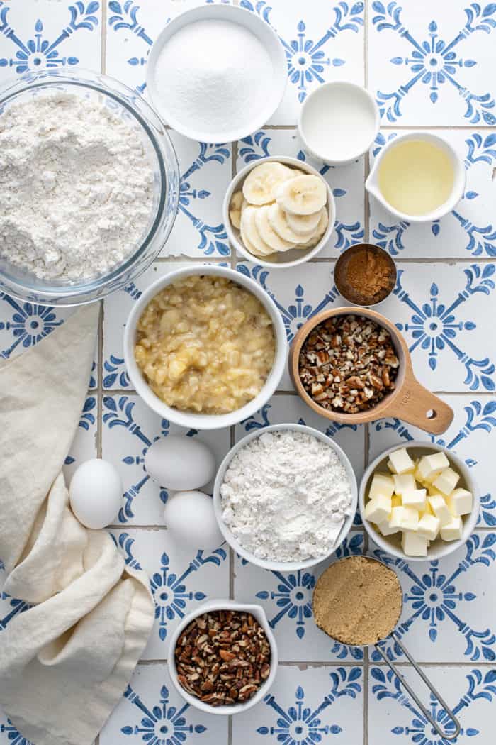 Ingredients for make-ahead banana coffee cake arranged on a blue and white tiled counter