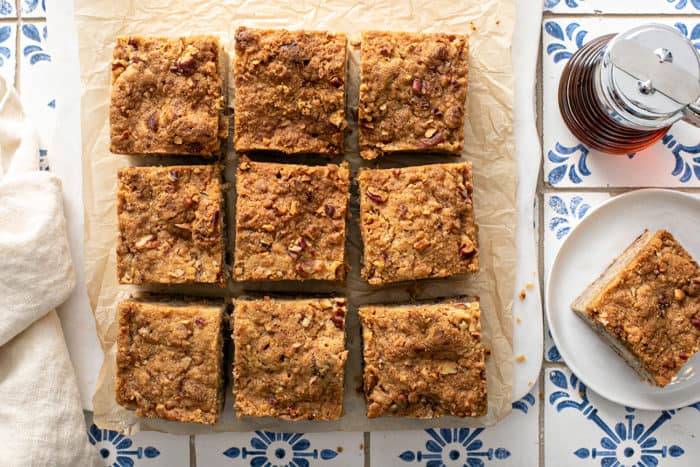Banana coffee cake cut into pieces on a piece of parchment paper