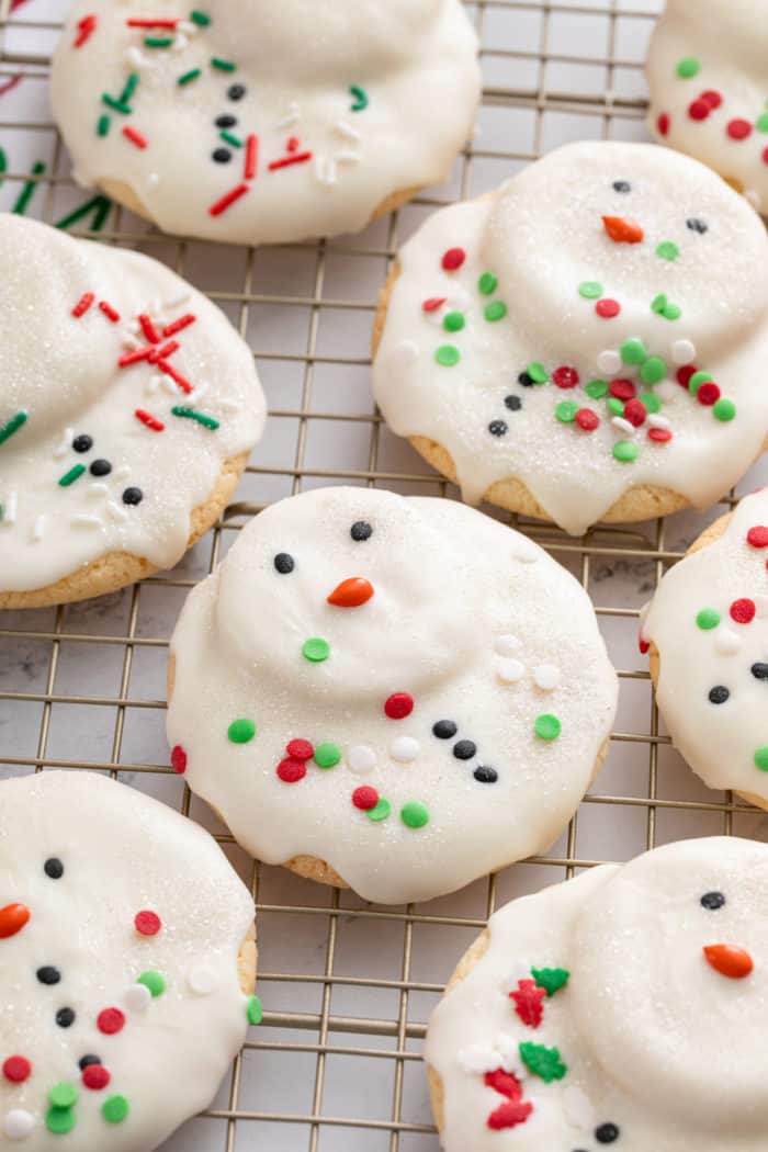 Close up of melted snowman cookies on a wire rack.