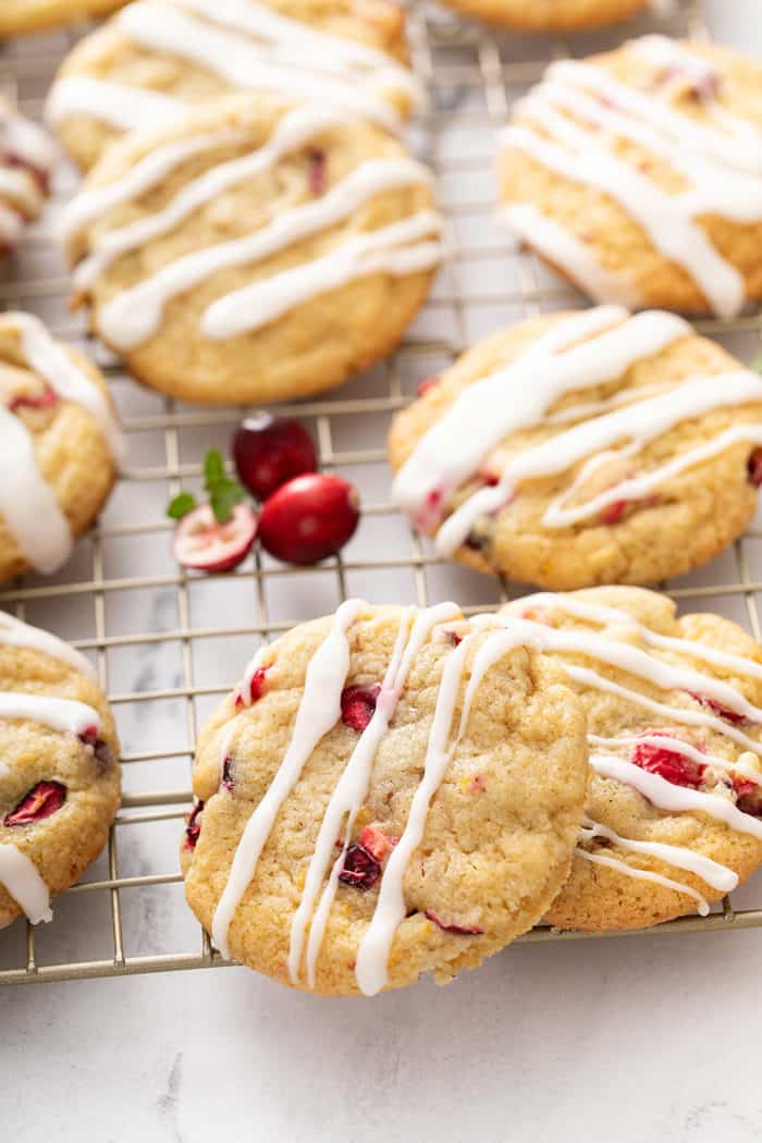 Close up of orange cranberry cookies drizzled with icing