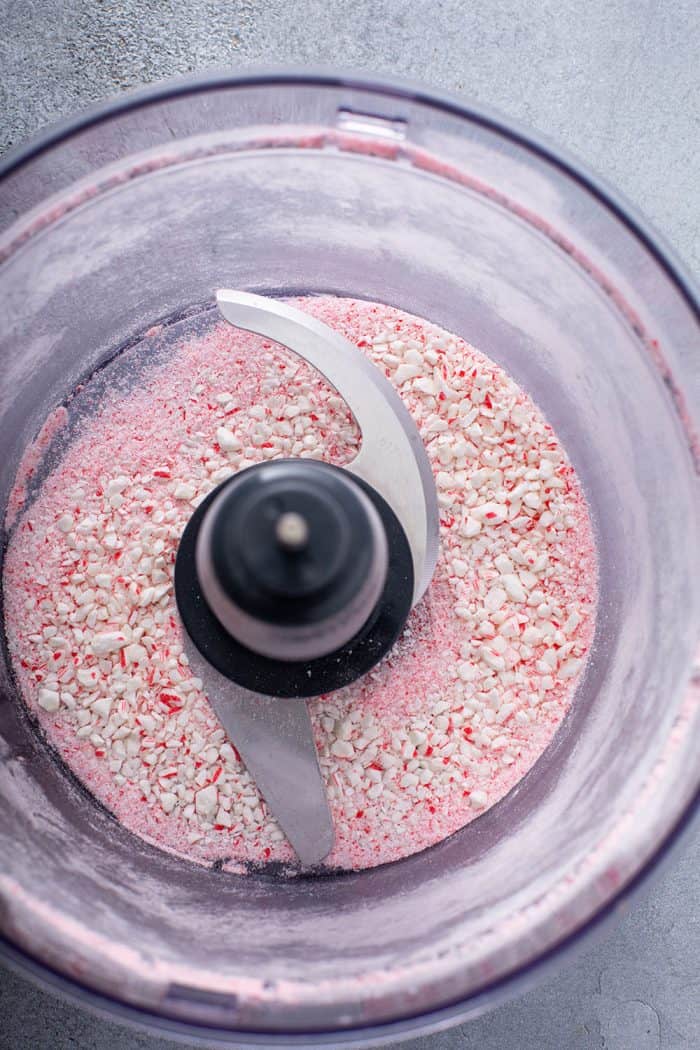 Crushed candy canes in the bowl of a food processor