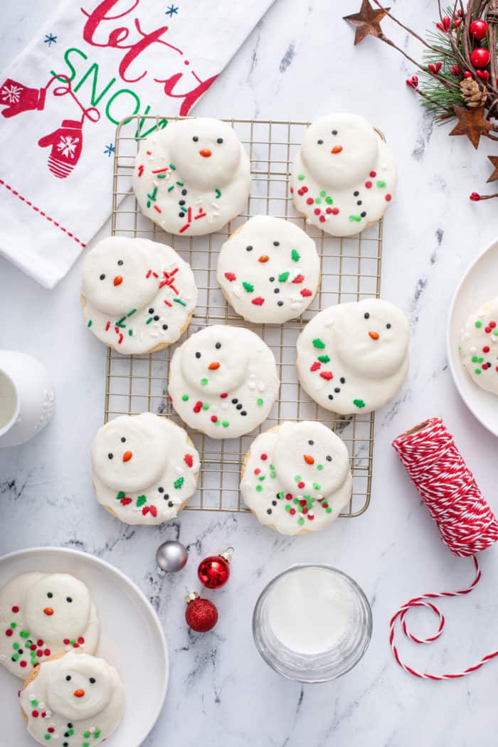 Overhead image of melted snowman cookies on a wire cooling rack.