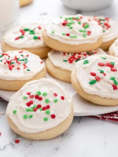 Sour cream sugar cookies on a white platter.