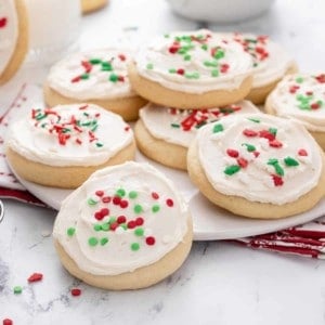 Sour cream sugar cookies on a white platter.