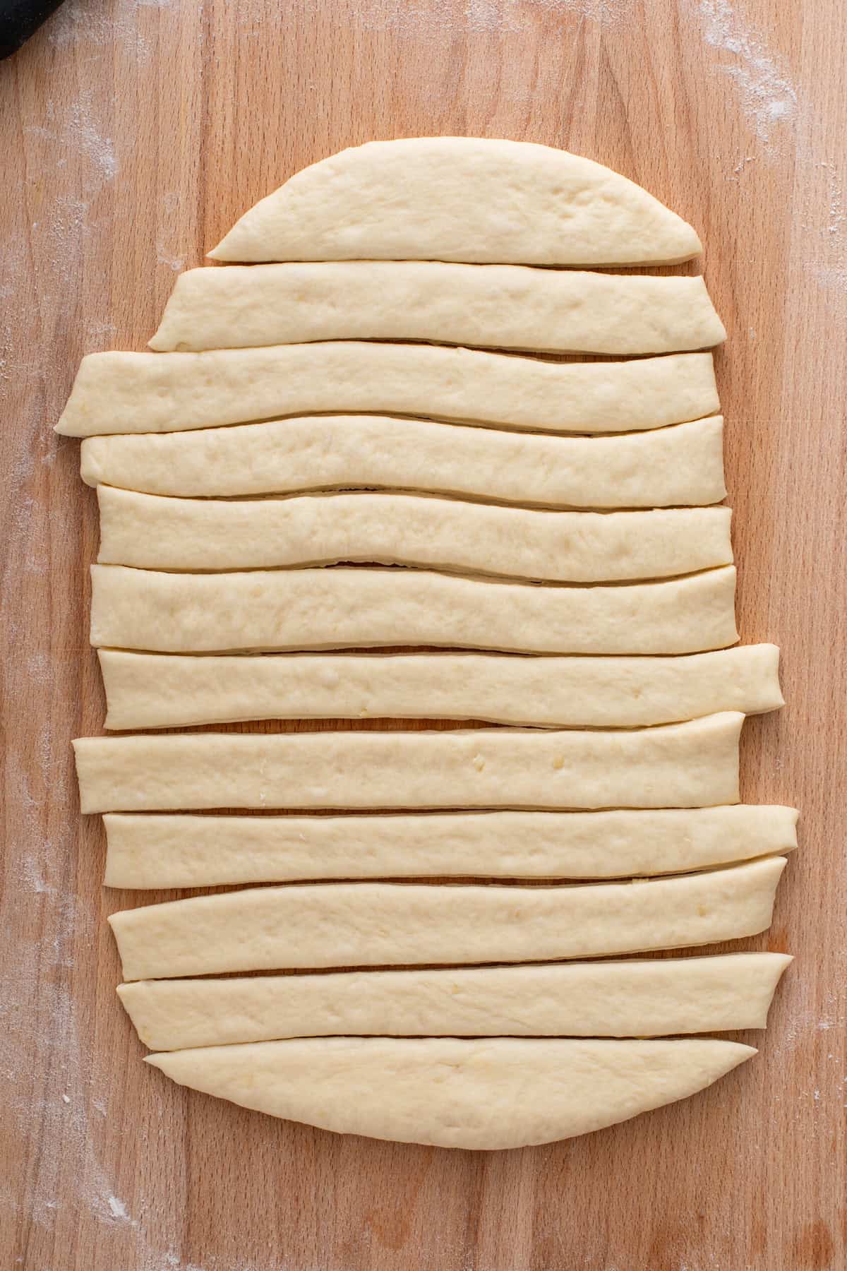 Dough cut into strips for bow knot rolls.