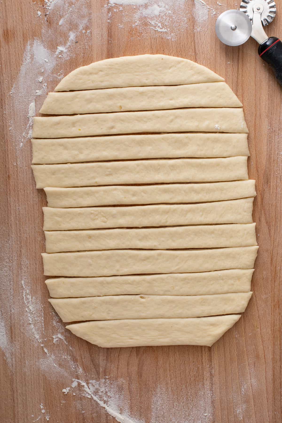 dough cut into strips for curlicue dinner rolls.