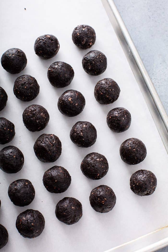 Shaped peppermint oreo balls arranged on a parchment-lined baking sheet