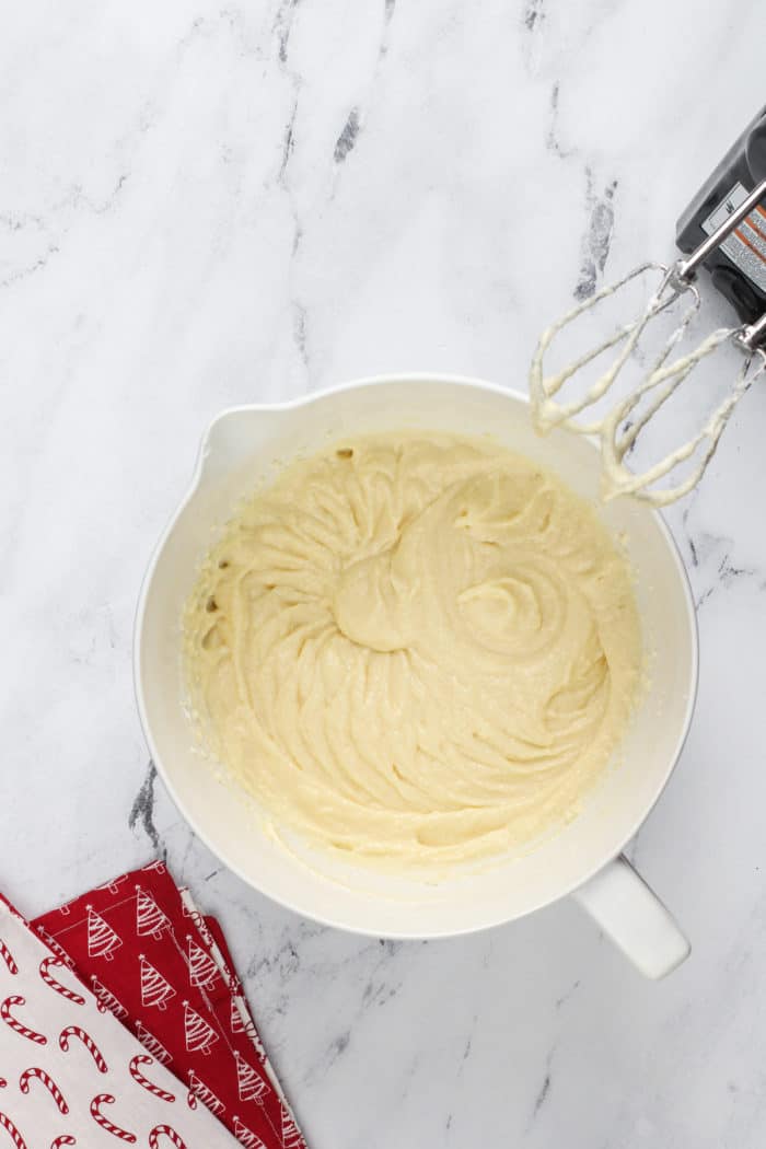 Wet ingredients for sour cream cookies mixed in a white bowl.