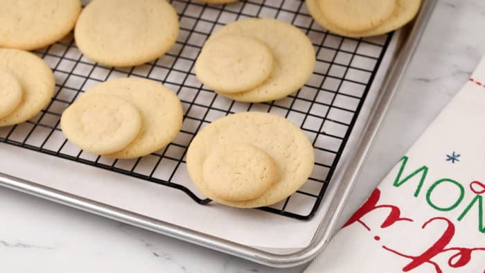 Small sugar cookies glued to the top of larger sugar cookies for melted snowman cookies.