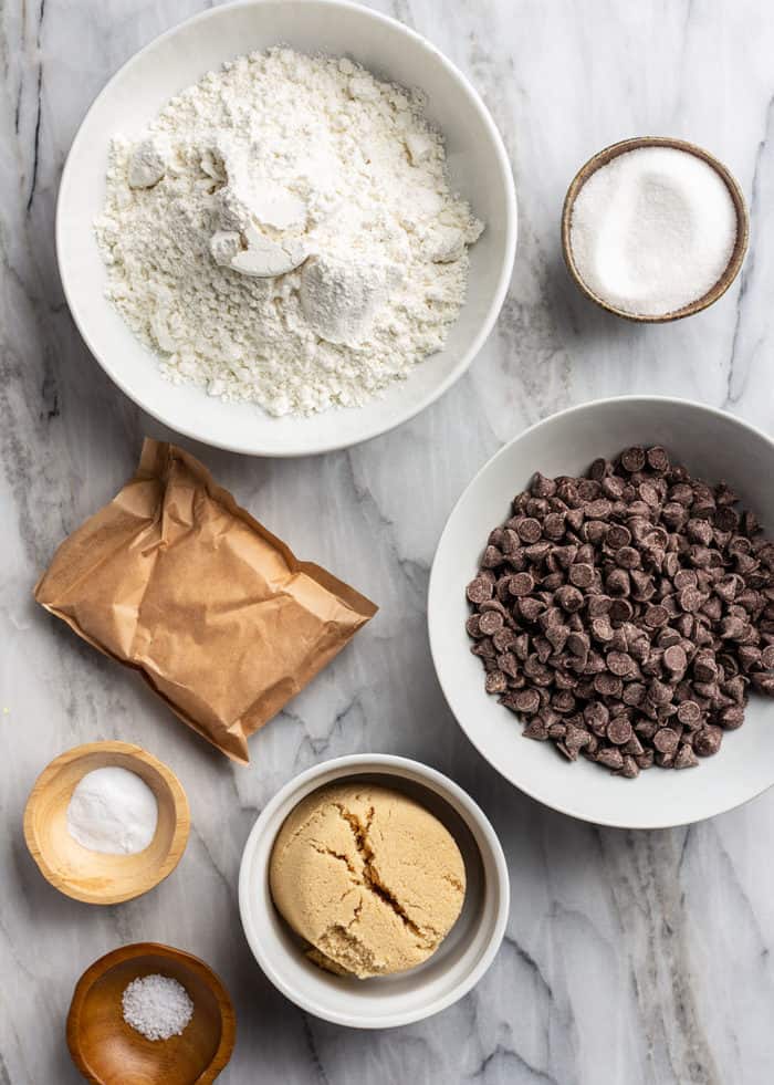 Ingredients for chocolate chip pudding cookies arranged on a marble countertop