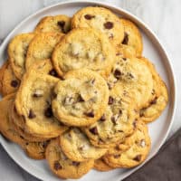 White platter filled with chocolate chip pudding cookies, set on a marble countertop