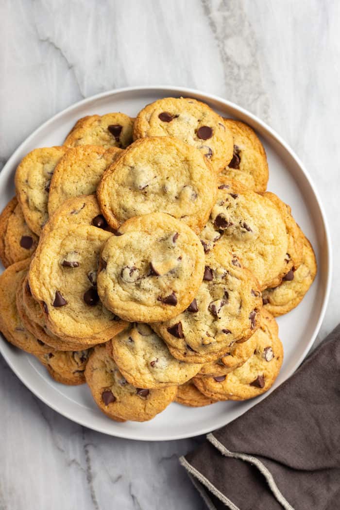 White platter filled with chocolate chip pudding cookies, set on a marble countertop