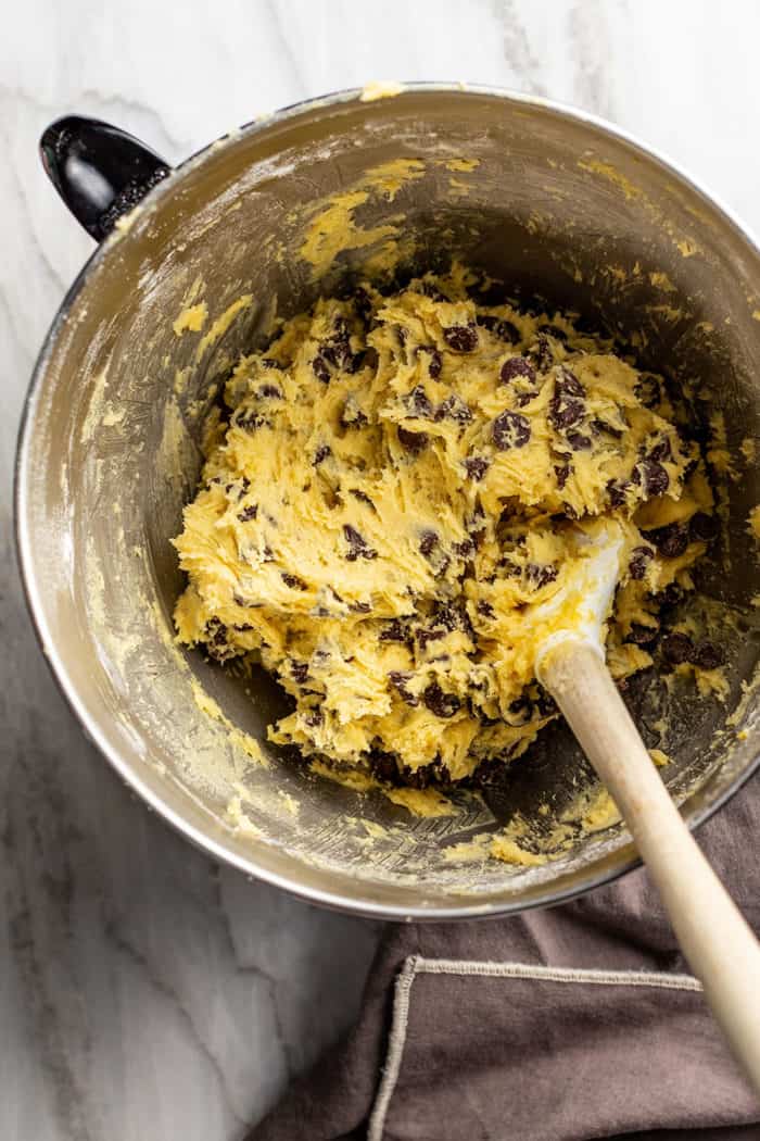 Spatula in a metal bowl filled with chocolate chip pudding cookie dough